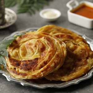 Close Up Roti Canai or Paratha with Chicken Curry